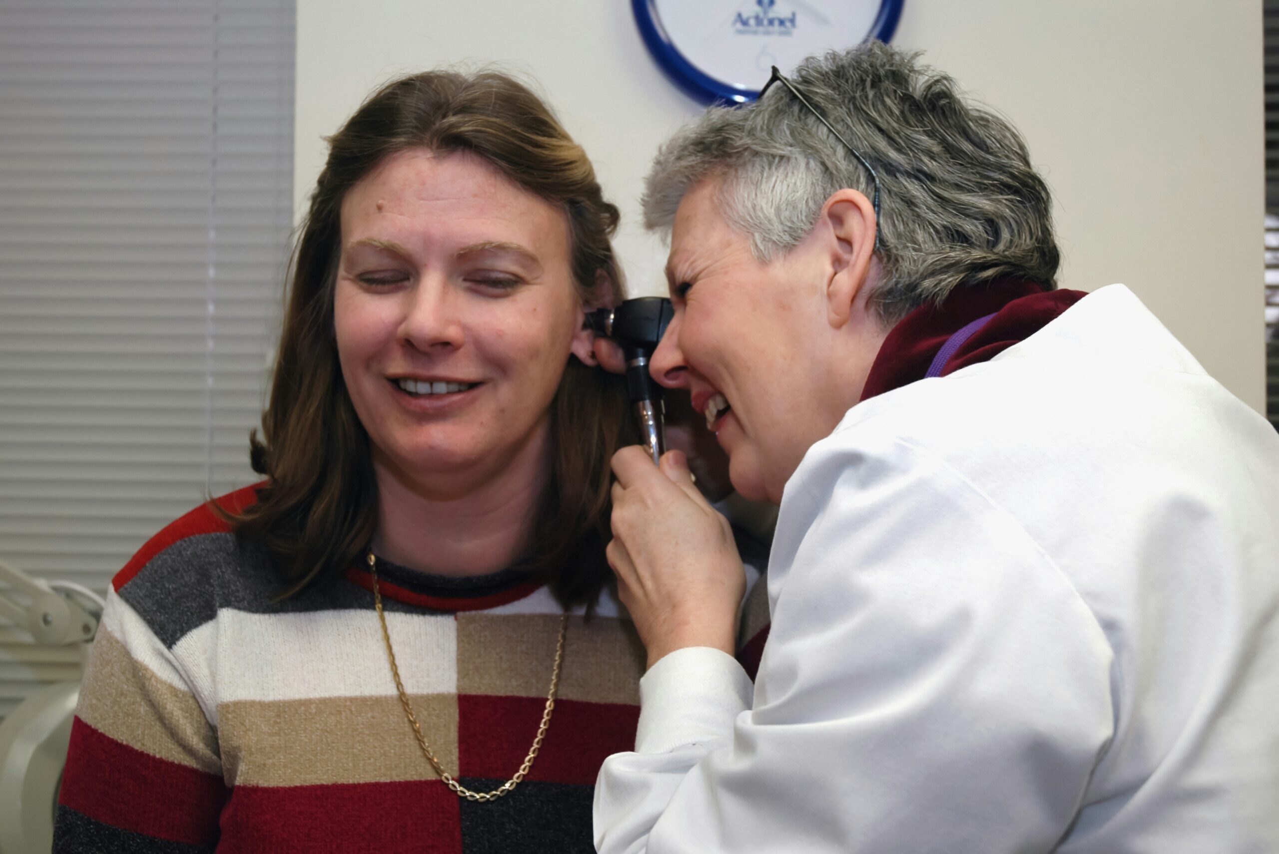 a woman talking on a cell phone next to a man